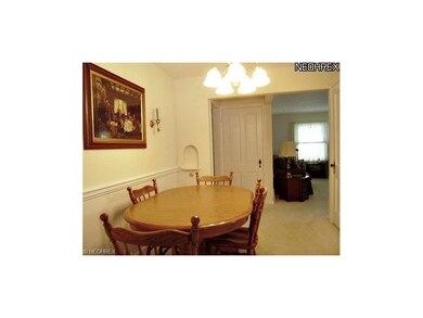 View of dining room looking into the living room (on right). The door at the back of the photo leads upstairs.