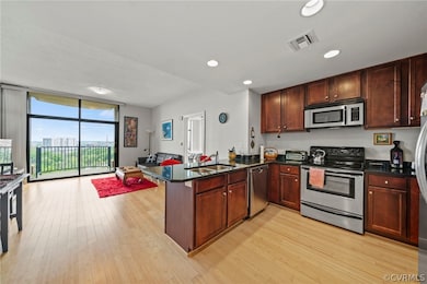 Kitchen featuring kitchen peninsula, expansive win