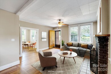 Virtually staged living area looking into office/dining area/3rd bedroom