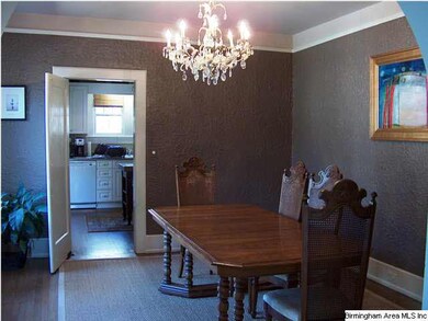 Dining room with original stuccoed walls, tall cei