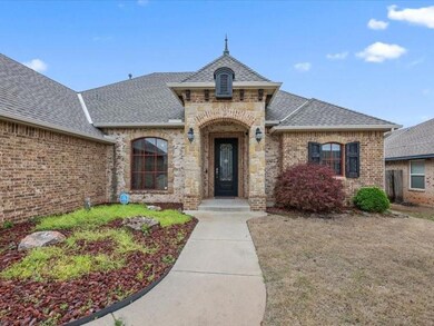 French country inspired facade with a front lawn