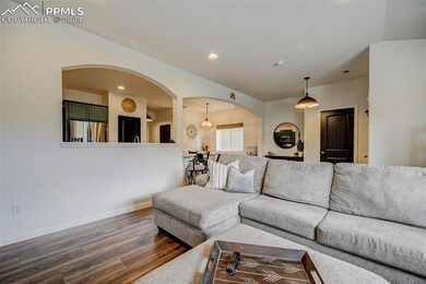 Living room with a chandelier and dark wood-type f