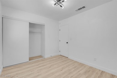 Unfurnished bedroom featuring wood finished floors