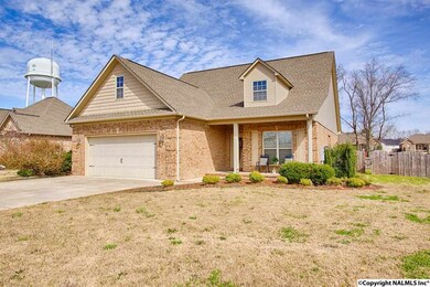 Showing the lush landscaping and the gate to the privacy fenced back yard.