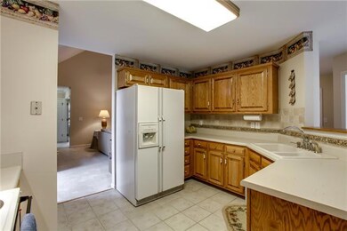 Spacious kitchen has great counter space. The kitchen boasts a tile back-splash, tiled floor and pantry.