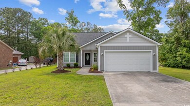 Single story home with a front lawn, driveway, and