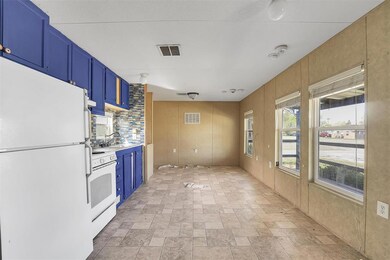 Kitchen featuring blue cabinetry, light tile floor