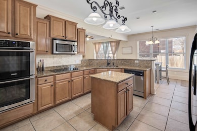 Kitchen featuring light tile patterned floors, sta