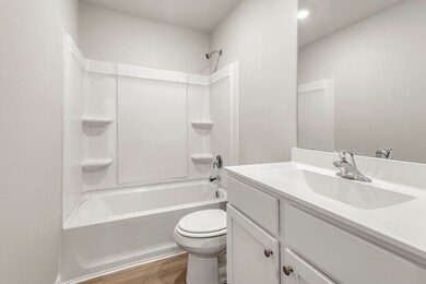 The secondary bathroom, located centrally in the hallway of the home.
