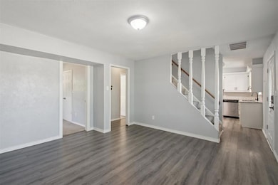 Front living room with dark wood-type flooring and