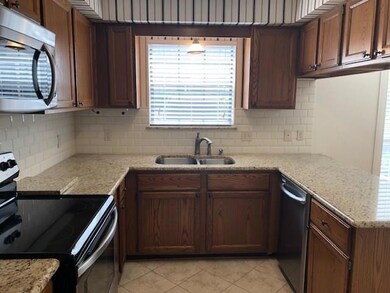 Stainless steel appliances and granite throughout 