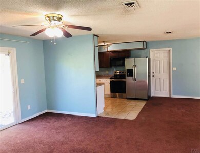 View from hall into dining and kitchen area.