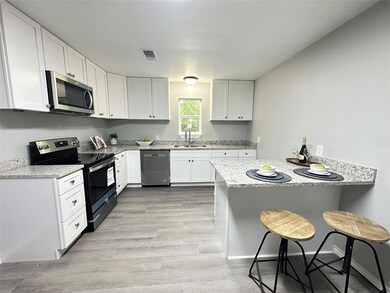 Kitchen with appliances with stainless steel finis