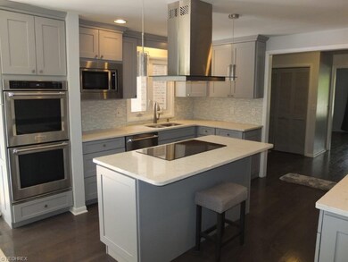 Kitchen has stainless steel appliances including K