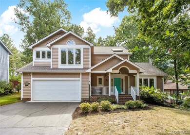 View of front of property featuring garage, a porch, and a front lawn