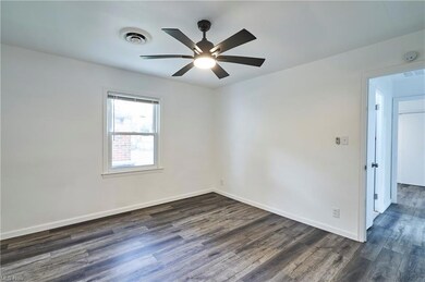 Wood floored empty room with ceiling fan