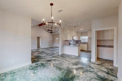 Kitchen with tasteful backsplash, visible vents, o
