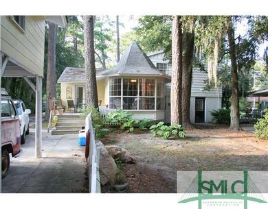 Exterior Back. Treed Backyard and Carport/Storage 