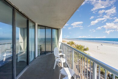 Balcony featuring a water view and a view of the b