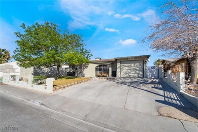 View of front of home with a garage, driveway, and