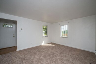 Freshly painted living room with new carpet!