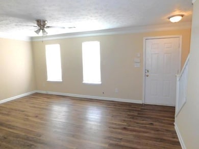 Unfurnished room with a ceiling fan, dark wood-sty