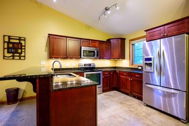 Kitchen featuring vaulted ceiling, kitchen peninsu