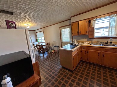Kitchen with crown molding, a sink, visible vents,