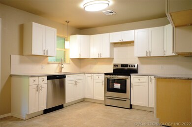 Kitchen.  Granite, tile, new cabinets, and stainle
