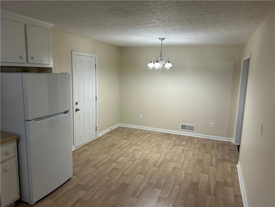 view from kitchen towards eating area, door to rea