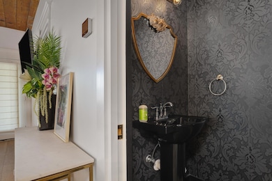 Bathroom with wallpapered walls