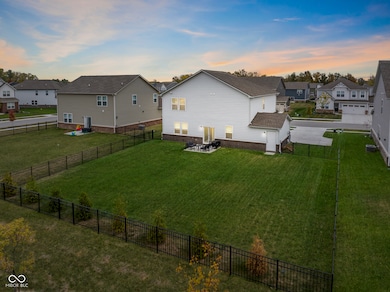Backyard - Fully Fenced, 7 large arborvitae trees planted on rear lot line that will grow to large size, backs to common space, backyard access via 3rd car bay, large, flat yard excellent for everyday life