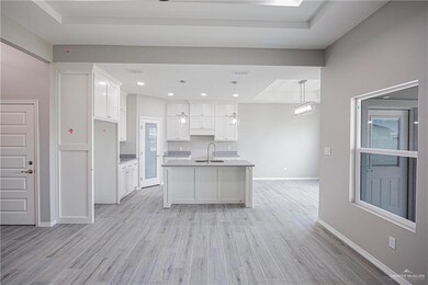Foyer entrance featuring a chandelier, marble finish flooring, and a raised ceiling