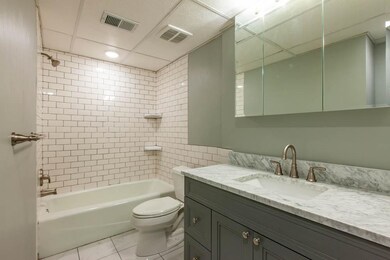 Gorgeous bathroom has new tile and granite
