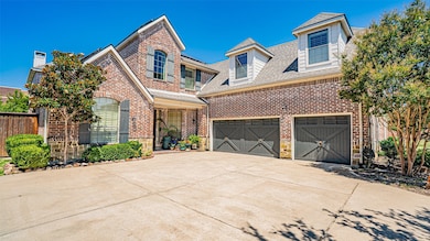 View of front of property with driveway, roof with shingles, and brick siding