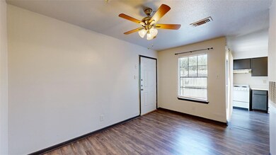 Unfurnished room with a textured ceiling, dark har