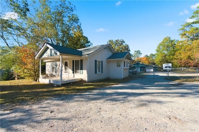 View of front of home featuring a porch and driveway