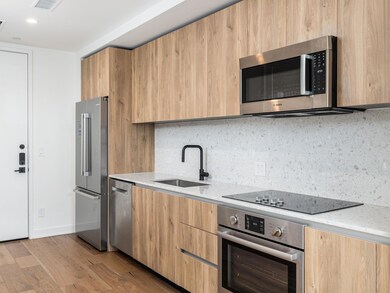 Kitchen featuring a sink, light wood-style floori