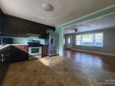 View of open kitchen and living room from side door