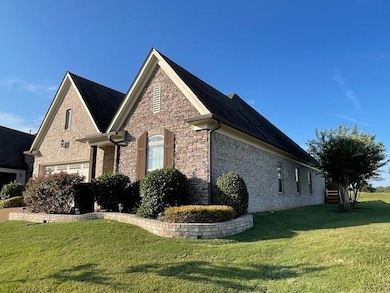 View of side of home featuring a yard