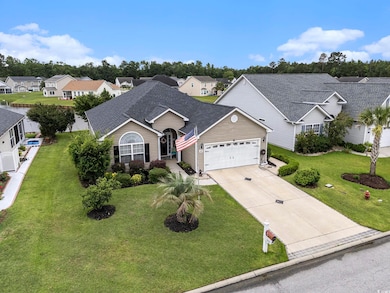 View of front facade with an attached garage, a shingled roof, concrete driveway, a residential view, and a front yard