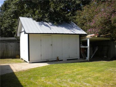 Exterior Back. Shop/Shed it has electricity and al