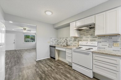 Kitchen with white electric range oven, under cab