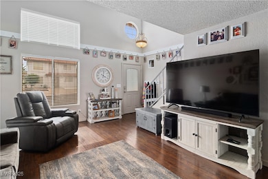 Living area with stairway, dark wood finished floo