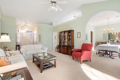 Living room featuring ceiling fan with notable cha