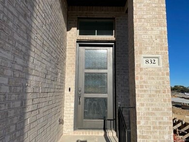 Doorway to property featuring brick siding