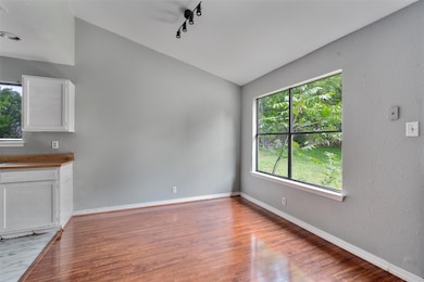Unfurnished living room with vaulted ceiling, lig