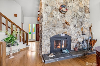 floor-to-vaulted ceiling stone fireplace