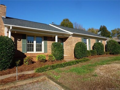 Front view- extra parking in framed gravel parking
