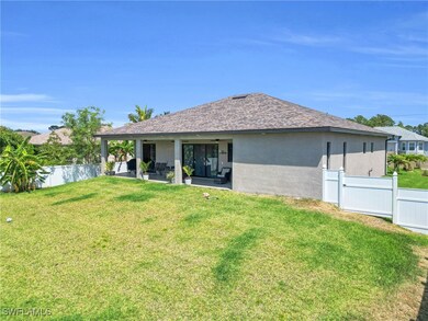 Back of property featuring stucco siding, a yard,